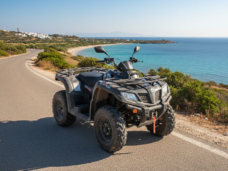 Stylish scooter for hire in Paros with Cycladic architecture and sea view in the background.